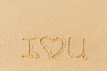 Valentine's day on a sunny beach. Text I love you. Declaration of love painted on the sand. Love concept. Relax on the sandy beach. Copy space.