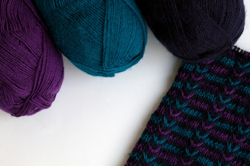 colourful wool yarn for knitting and knitting as background with copy space top view