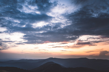 Sunset behind the mountains in national park Krkonose, Czech Republic