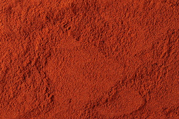 Red paprika powder background and texture