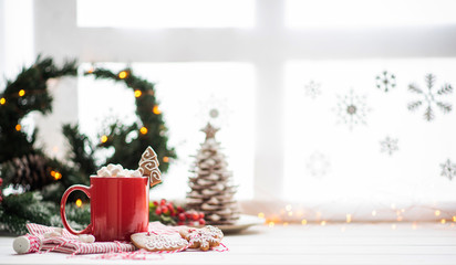 Vintage Christmas background. Christmas breakfast and decoration against winter window. Cup of coffee, coffee pot and gingerbreads. Christmas family morning. Copy space for your text.