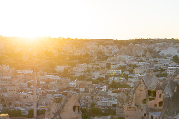 Aerial view on Goreme town in Cappadocia during sunset. Landscape of city.
