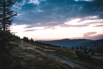Naklejka na ściany i meble Sunset behind the mountains in national park Krkonose, Czech Republic