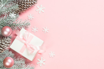 Christmas flat lay background with christmas present box on pink.