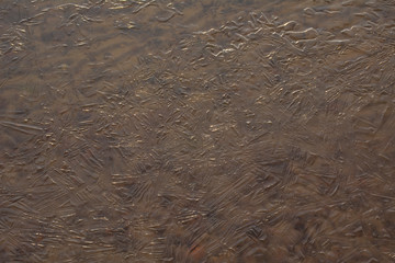 Transparent water and ice near the shore of the river
