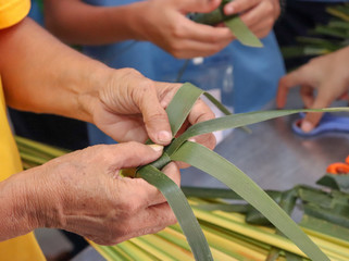 people making handmade basketry. Fish made from coconut leaf.