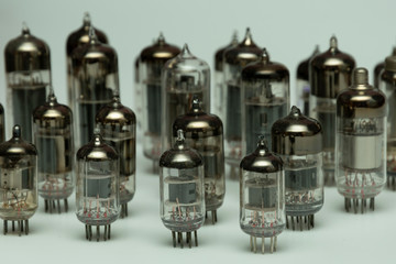 different vintage vacuum lamps for electronic amplifiers, audio players and tube TVs on a white...