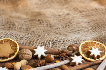 christmas cookies and spices on braun background - obrazy, fototapety, plakaty