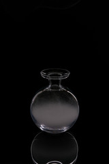 A glass bowl-shaped bathtub filled with smoke.