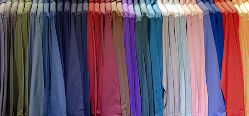 Close up of Multi colored shirts on hangers, Colorful apparel cloth background