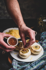Sprinkling spices on the stuffed button mushrooms