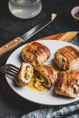 Bacon-wrapped button mushrooms stuffed with cheese