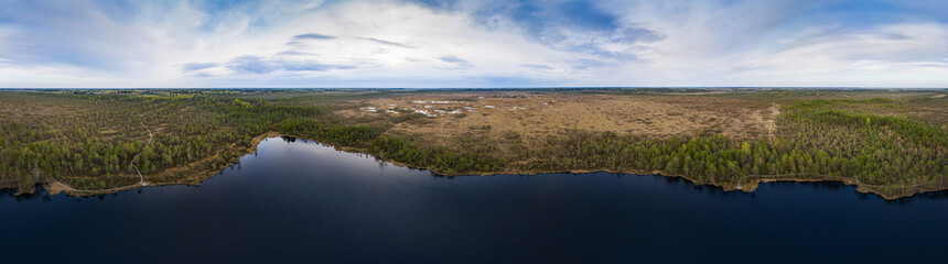 Sunset in the bog, golden marsh, lakes and nature environment. Sundown evening light in spring