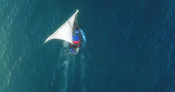 Traditional dhow sailboat sailing on the Indian ocean on the Swahili coast filmed with a drone, Tanzania.
