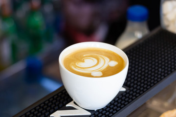 Latte art in a coffee shop, a bear pattern on coffee