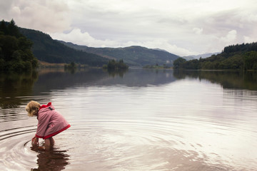 Little girl playing in a Scottish Loch