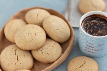 A mug of morning coffee on a table with delicious homemade cookies.
