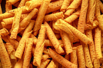 Cheddar cheese tortilla rolls, chips close up, background.