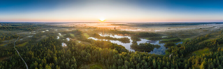 Obraz premium Sunrise in the bog landscape. Misty marsh, lakes nature environment background