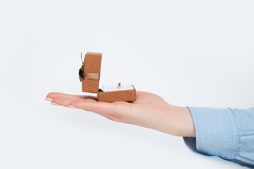 Open brown jewelry box with ring in female hand. Present. Isolate