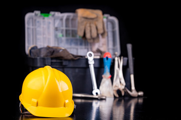 Tools in the chest and helmet of the production worker. Accessories for workers in the workshop.