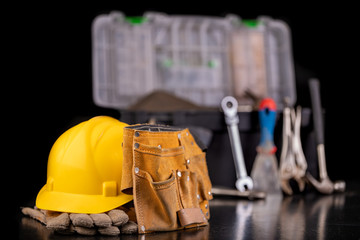 Tools in the chest and helmet of the production worker. Accessories for workers in the workshop.