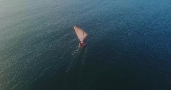 Traditional dhow sailboat sailing on the Indian ocean on the Swahili coast filmed with a drone, Tanzania.