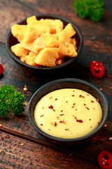 Homemade Cheese Sauce with spice on wooden table