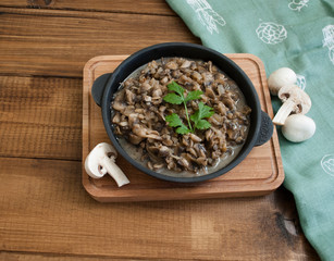 pan of fried mushrooms on a wooden board