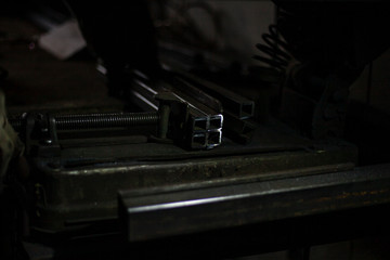 Metal profile in a dark workshop. Material to create the structure.