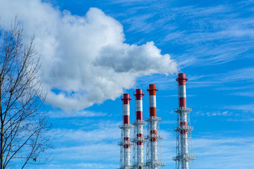 Smoke pollution. Smoke pipes against the blue sky