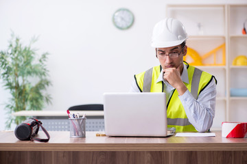 Young male architect working in the office