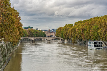 Fototapeta premium Rome, Italy Tiber river high tide water rise. Day view of high water level flooding the banks of the river crossing the Italian capital, after heavy rain.