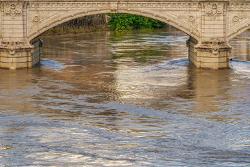Obraz premium Rome, Italy Tiber river high tide water rise. Day view of high water level flooding the banks of the river crossing the Italian capital, after heavy rain.