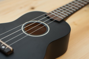 ukulele on a wooden background