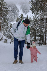Fototapeta na wymiar Dad and daughter Winter in mountains