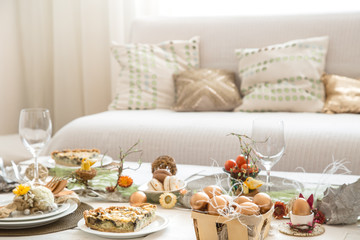 The interior of the room with a festive Easter table .