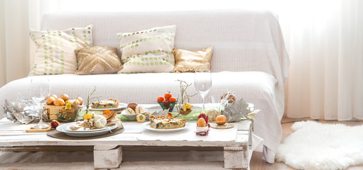 The interior of the room with a festive Easter table .