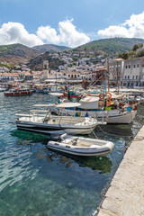 Fototapeta na wymiar Boats in the pier with houses and buildings in background in Hydra Island