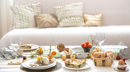 The interior of the room with a festive Easter table .