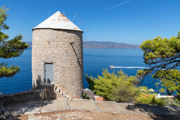 Fototapeta na wymiar Old wind mill with ocean in background in Hydra Island