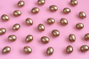 Background with Easter eggs in gold color.