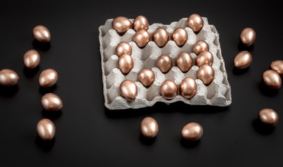 Background with Easter eggs in gold color.