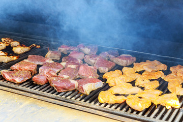 Steak on the grilled chicken salmon and beef with flames