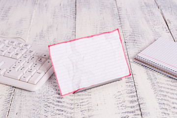 Notepaper stand on buffer wire in between computer keyboard and math sheets