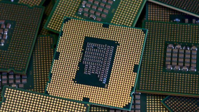 Closeup on many Computer CPU Chip rotating. Selective focusing.