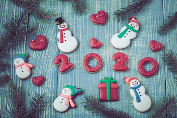 Festive new year gingerbread on a wooden background.
