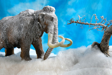 Prehistoric woolly mammoth model diorama scene