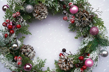Fototapeta na wymiar Cristmas wreath under snowflakes. Winter background