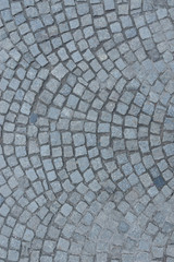 Road of paving stones background texture. Grey cobblestone texture background. Gray granite cobbled path texture.